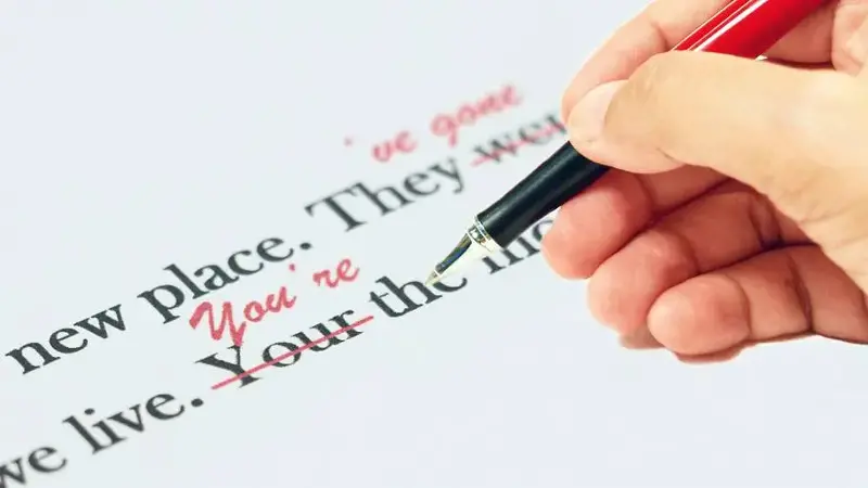proofreading of English sentences on white paperwork