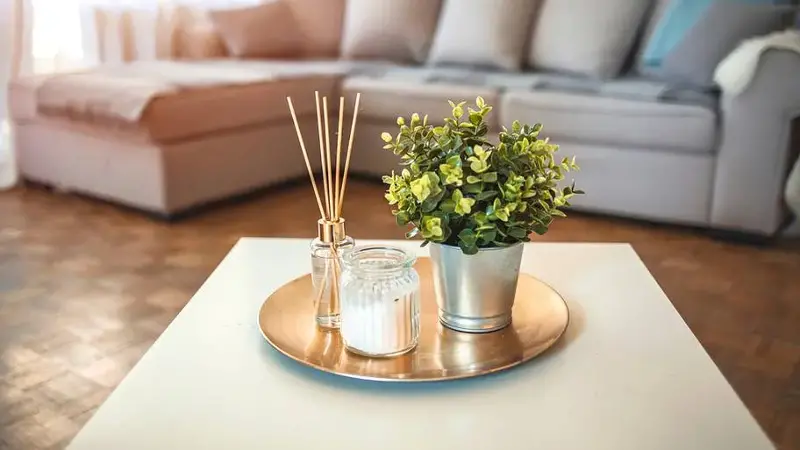 Diffuser and candle sitting on table