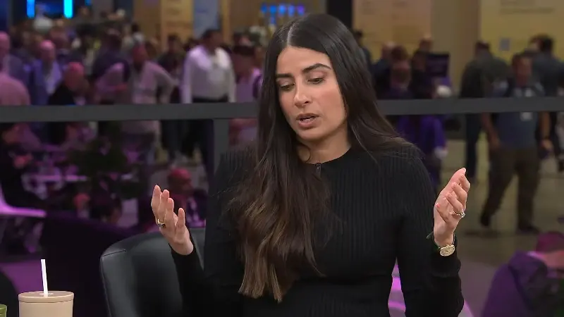 Asha Sharma in black sweater
