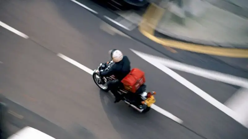 Motorcycle courier or Pizza delivery speeding