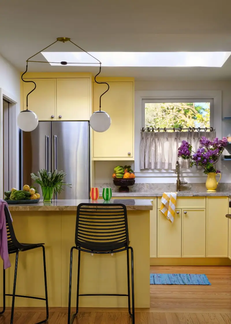 The kitchen is drenched in the pleasing Sherwin-Williams Friendly Yellow. Suzanna Scott Photography. Design: Spearman Spaces