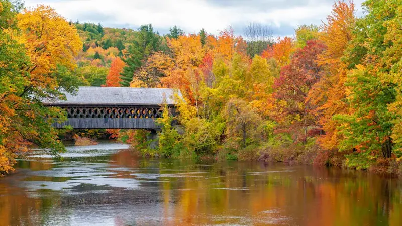 Covered Bridge with Peak Autumn Color along Contoocook River, New Hampshire, USA