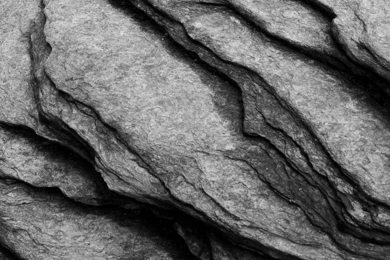 Detailed close-up of layered rock formation, showcasing natural texture.