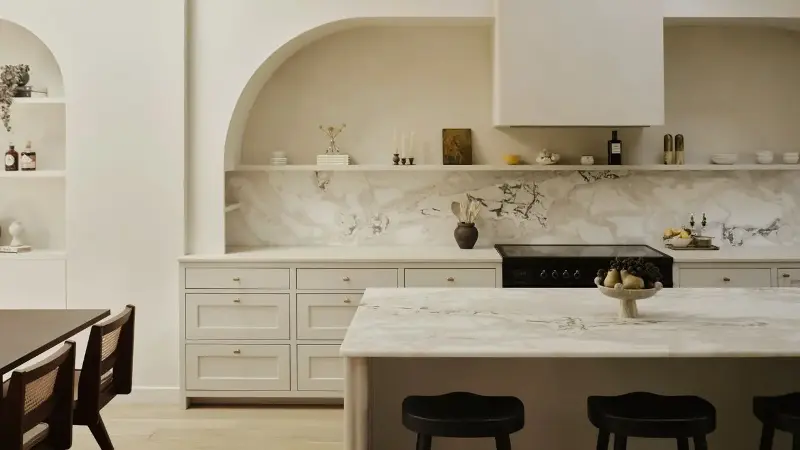 Allowing architectural details to shine makes an off-white kitchen so much more inviting.