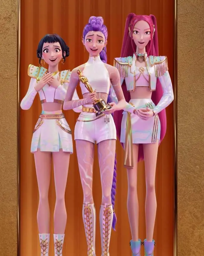 KPop Demon Hunters characters posing together, one holding an award, all dressed in stylish outfits.