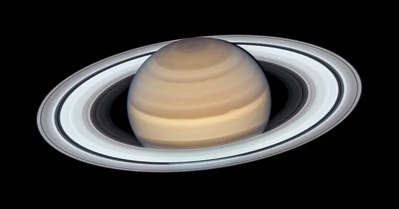 Full-disk view of Saturn and its rings against black space.