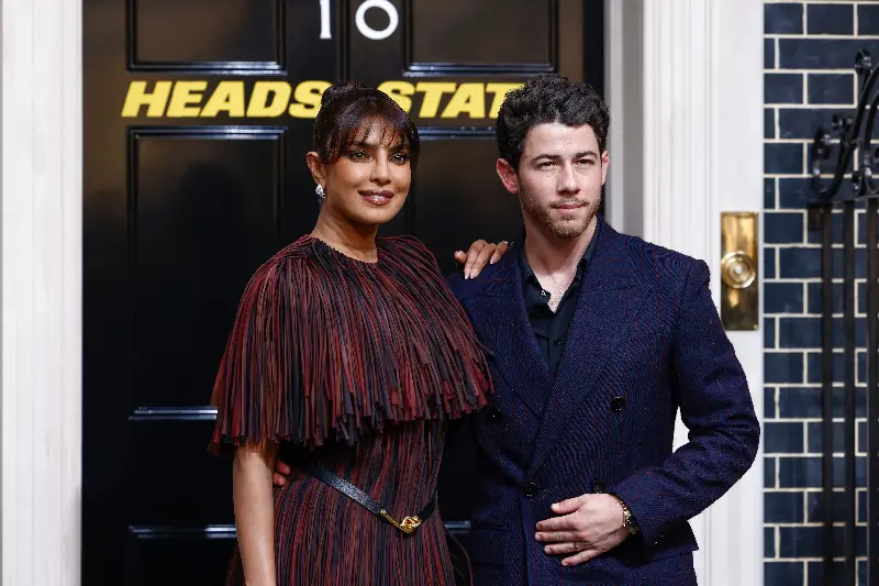 Priyanka Chopra, left, and Nick Jonas pose for photographers upon arrival at the premiere for the film 'Heads of State'.