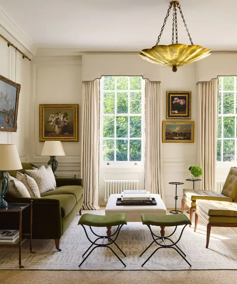 Living rooms layered with stools, side tables, and tiny ottomans are 'comfortable and adaptable.' (Image credit: Boz Gagovski)