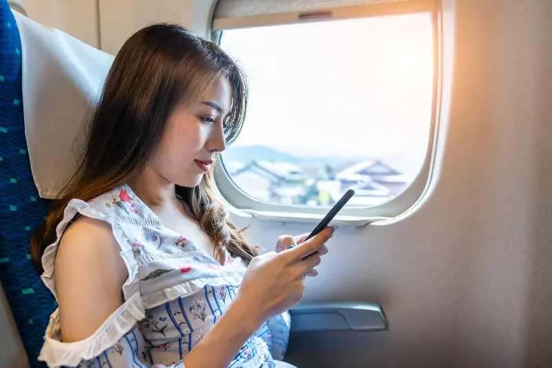 woman using smartphone train (1) (1).jpg