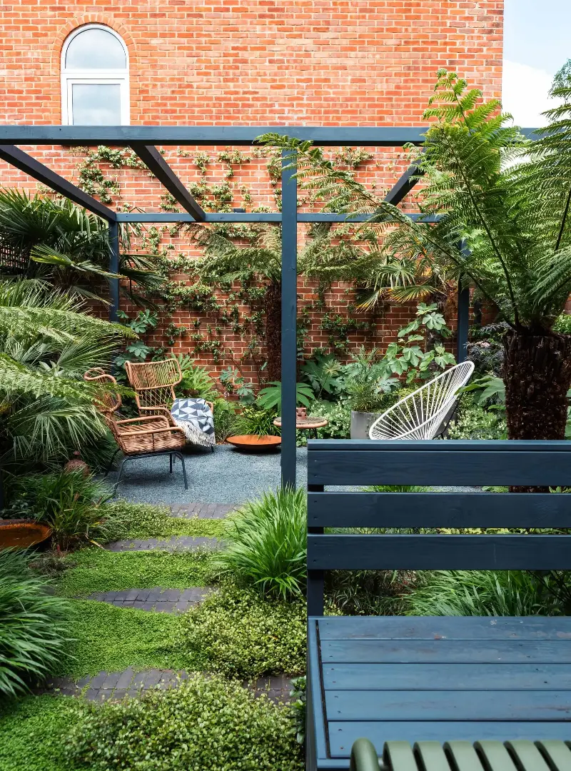Creating garden zones, whether through pergolas, planter boxes, or walls, helps to expand the feeling of your narrow garden.  (Image credit: Ellie Walpole. Design: GRDN)