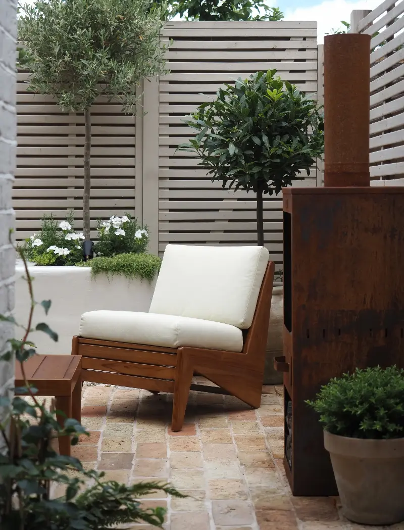 Horizontal slatted fences help trick the eye into thinking the space is wider than it really is.  (Image credit: Luke Arthur Wells)