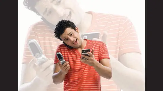 Americans are carrying two, even three cellphones to separate work and personal life. Are they OK? (ADOBE STOCK)