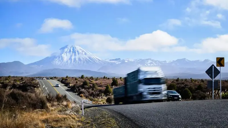 Traffic on Desert Road. Mt Ngauruhoe in the distance. State Highway 1. North Island. New Zealand.