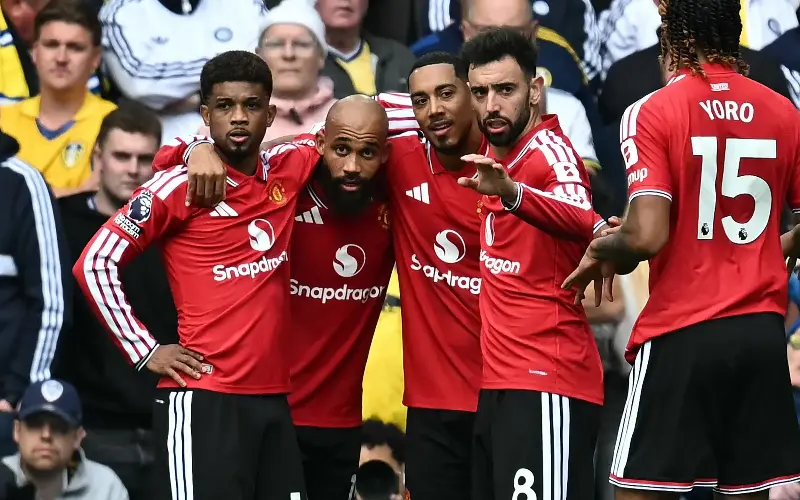 Manchester United players celebrate with Bryan Mbeumo - AFP/Paul Ellis