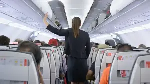 Why Do Flight Attendants Sit on Their Hands During Takeoff?