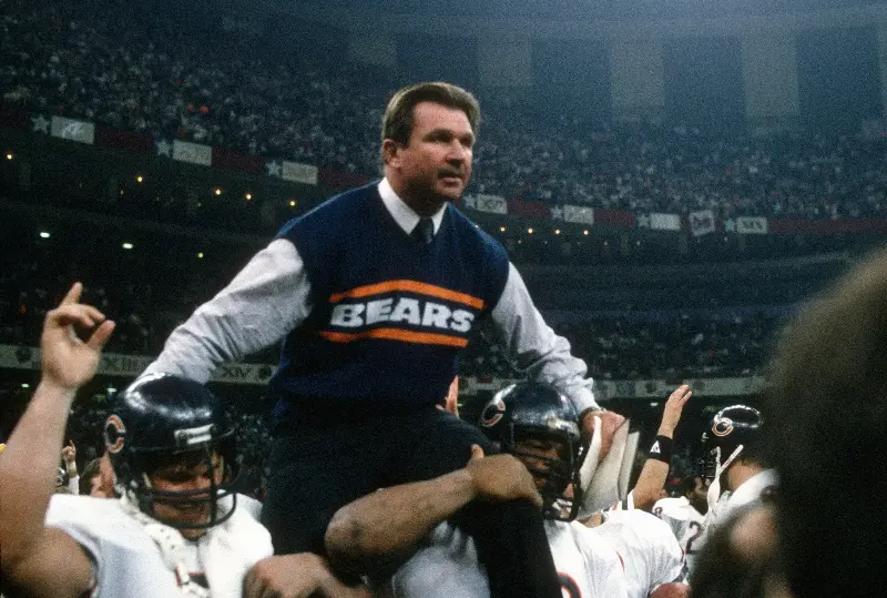 NEW ORLEANS, LA - JANUARY 26:  Head Coach Mike Ditka of the Chicago Bears gets carried off the field after they defeated the New England Patriots in Super Bowl XX January 26, 1986 at the Louisiana Superdome in New Orleans, Louisiana. The Bears won the Super Bowl 46-10. (Photo by Focus on Sport/Getty Images)