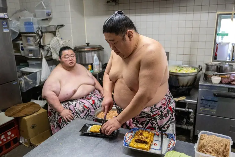 TOPSHOT - This picture taken on January 8, 2026 shows sumo wrestlers cooking a 