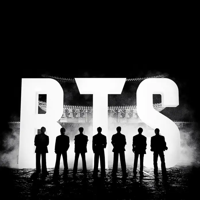 Silhouettes of seven individuals standing in front of a large illuminated sign that reads 'BTS', with a dark background and mist creating a dramatic effect.