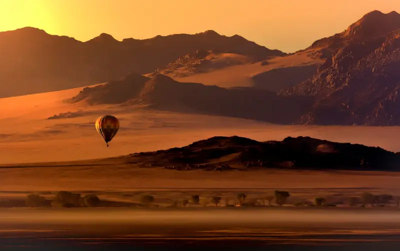 Witness the vivid red and orange sands of the world’s oldest desert from above - iStockphoto