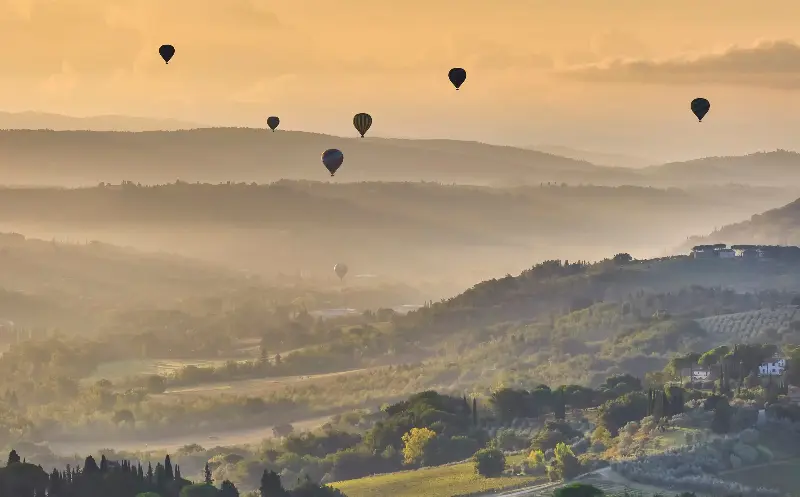 Hot-air balloons fly over Tuscany’s Val di Pesa at sunrise - Andrea Pistolesi