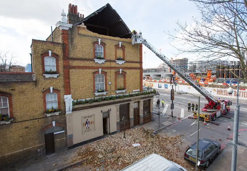 Members of London Fire Brigade assess the damage at a pub after Storm Katie hit the capital in March 2016 (AFP/Getty)