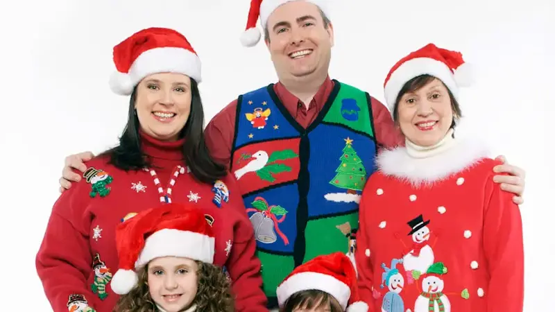 family wearing ugly christmas sweaters