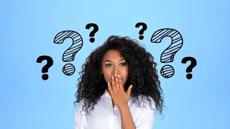 Businesswoman covering mouth with question marks around 