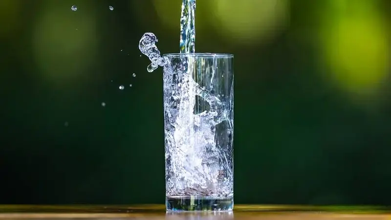 Clean water falling into a glass