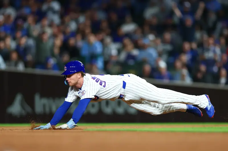 Pete Crow-Armstrong #4 of the Chicago Cubs dives for his 39th stolen base of the season during the third inning against the Miami Marlins at Wrigley Field on September 22, 2026 in Chicago, Illinois. (Photo by Isaac Wasserman/Getty Images)