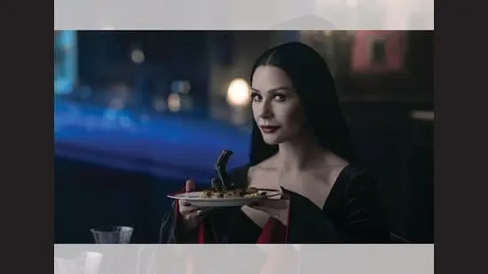 Nothing rattles Morticia Addams. Has any mommy looked this good in all-black?