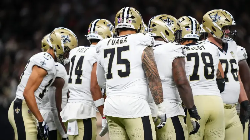 Taliese Fuaga #75 of the New Orleans Saints looks on from the huddle during an NFL football game against the Atlanta Falcons at Caesars Superdome on October 5, 2026 in New Orleans, Louisiana. (Photo by Perry Knotts/Getty Images)