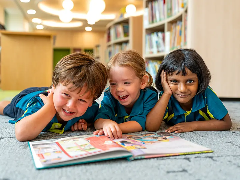 young students of Australian International School reading a book in the library