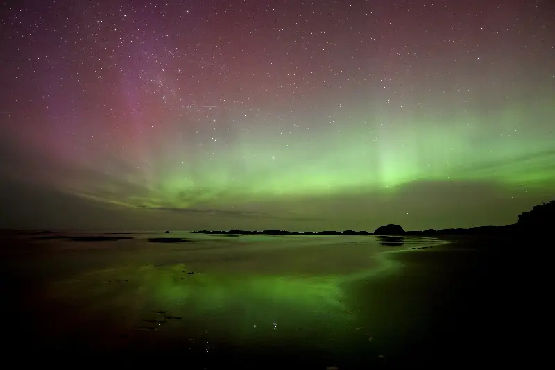 Aurora Australis, also known as the Southern Lights, glows on the horizon over the waters of Brighton Beach in Dunedin on November 13, 2025 (AFP via Getty Images)