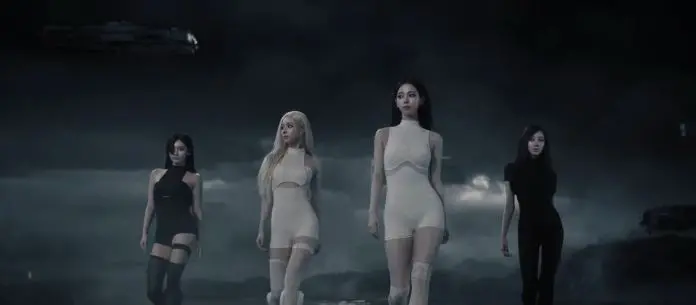 Aespa members walking confidently in a dark, atmospheric setting, wearing form-fitting outfits. The scene features an otherworldly background with mist and a spaceship in the sky.