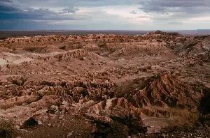 In the Martian sky, the sun appears roughly two-thirds the size it looks from Earth, and at sunset it glows blue rather than red — the same dust particles that make daytime skies pink on Mars scatter shorter wavelengths at dusk in exactly the opposite pattern to our atmosphere
