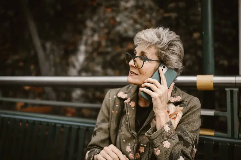 older woman phone kitchen