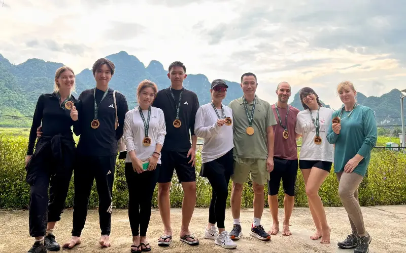 Lee Cobaj (far right) and her fellow adventurers were each awarded a bamboo medal to mark the end of the excursion - Lee Cobaj