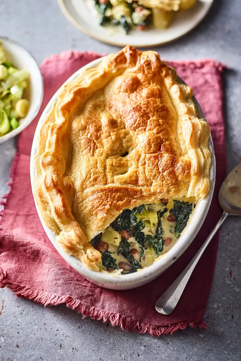 Cavolo nero, borlotti beans and potatoes sit beneath a crisp puff pastry lid in this easy meat-free pie (Discover Great Veg)