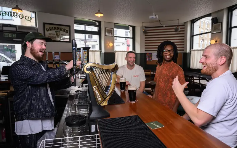 Rupert Moylett, pictured behind the bar, considers his Hackney pub to be ‘a third space’, providing a sense of community for his customers - Paul Grover