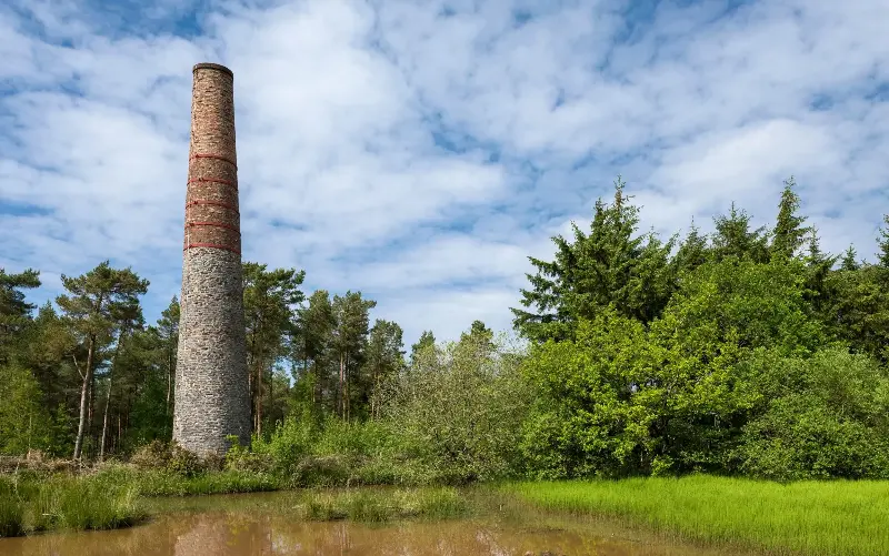 The chimney of an old lead mine pokes out of the foliage in East Harptree - Craig Joiner/ Alamy