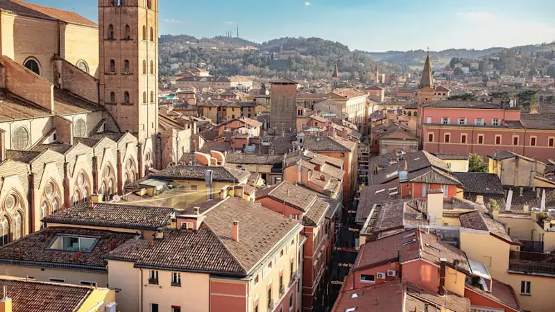 Residential houses and buildings surrounding Basilica di San Petronio with bell tower in Bologna, Italy