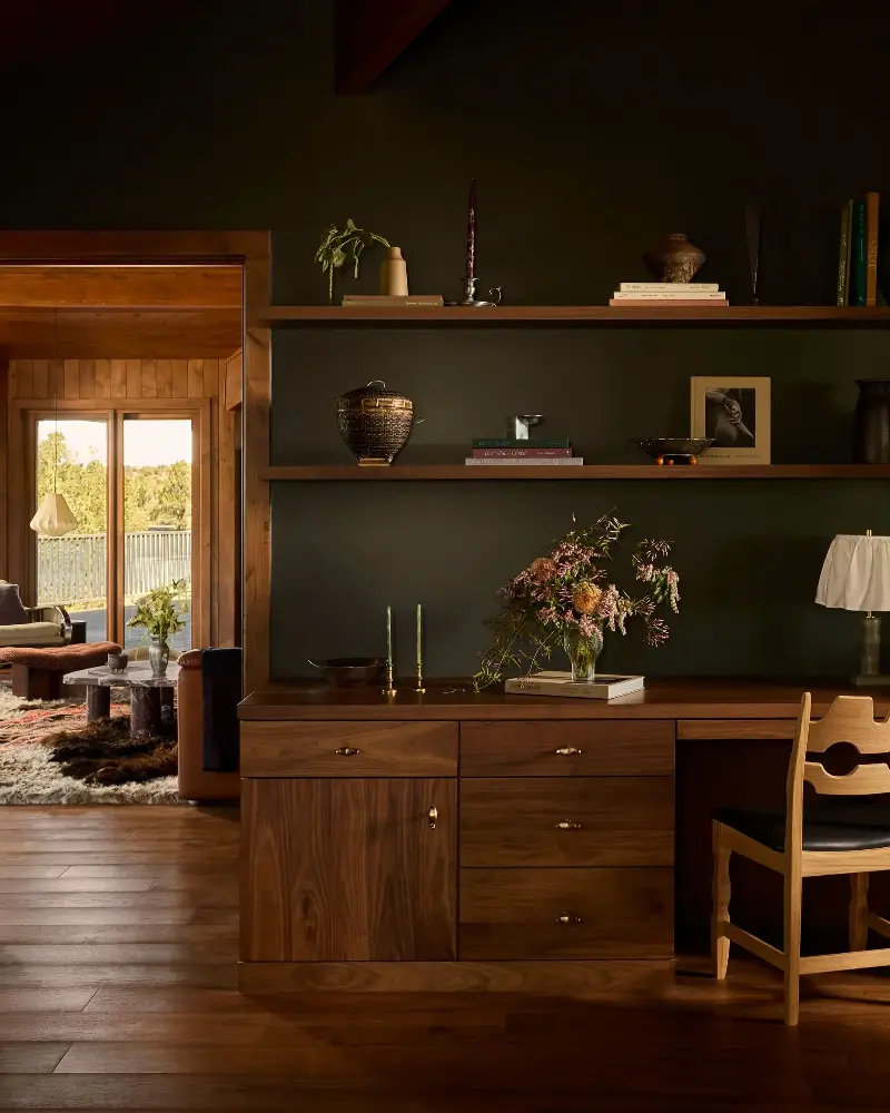 The rich green paint pairs perfectly with the warm wood, creating a sophisticated home office space.Malissa Mabey. Design: Susannah Holmberg Studios. Styling: Jen Paul