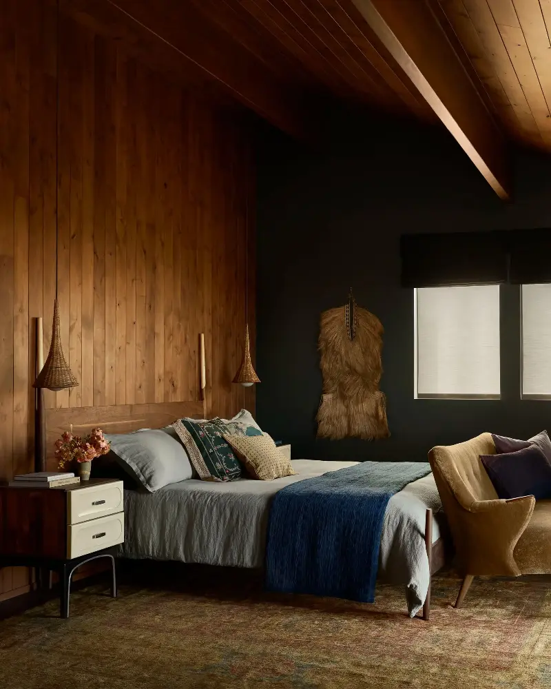 The wood-paneled backdrop in the tonal and tactile primary bedroom adds an enveloping warmth to this cozy space. (Image credit: Malissa Mabey. Design: Susannah Holmberg Studios. Styling: Jen Paul)