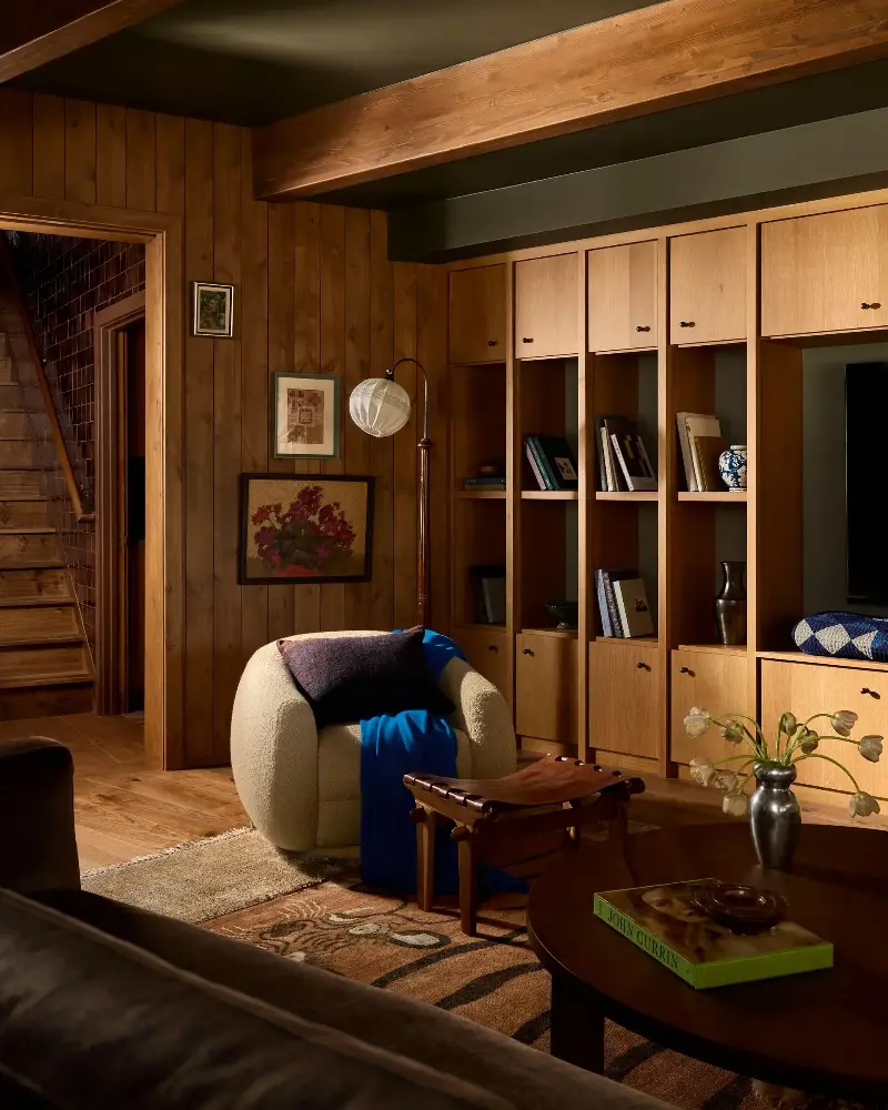 Cozy comfort is key — and this family room is a cocoon of warm joy, from the enveloping wood to the plush rug and comfortable seating that urges you to stay awhile. (Image credit: Malissa Mabey. Design: Susannah Holmberg Studios. Styling: Jen Paul)