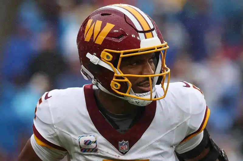 Jayden Daniels #5 of the Washington Commanders looks on against the New York Giants during the first half of the NFL game at Northwest Stadium on October 11, 2026, in Landover, Maryland. (Photo by Scott Taetsch/Getty Images)