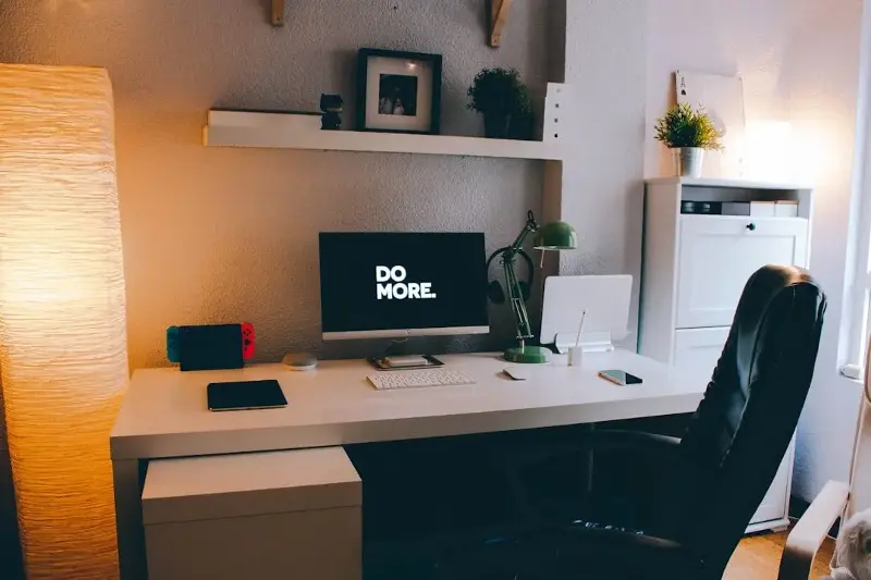 A small section carved out in a room that includes a small desk, chair, and lamps can help you keep work and personal life activities in their respective spheres.