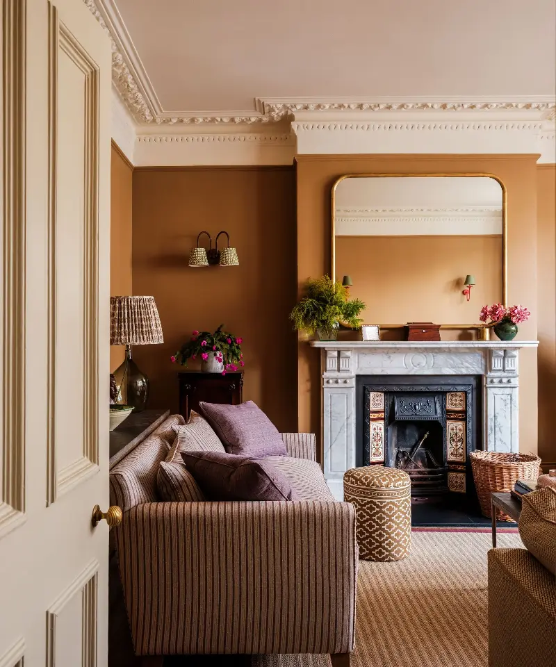 Cinnamon hues create warmth and ambience, perfect for snug spaces like living rooms or libraries. (Image credit: Laura Stephens)