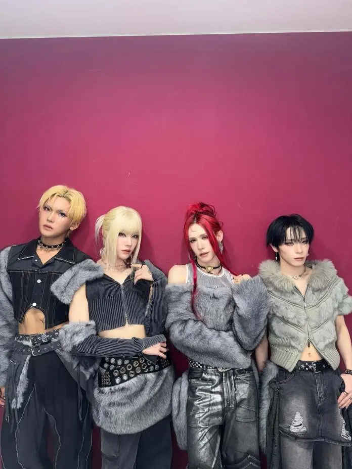 XLOV members posing together in trendy outfits featuring fur accents against a solid pink background.