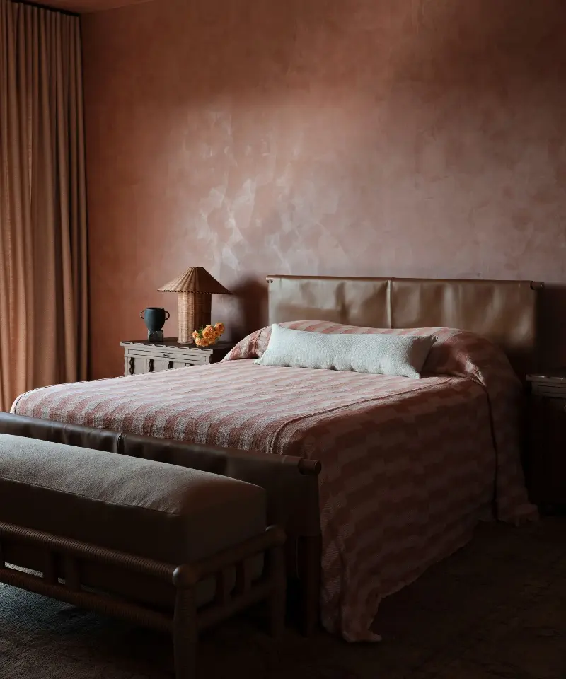 In this bedroom by Shane & Pierce, earthy brown and red undertones keep the pink from feeling sugary, while similarly warm textiles create a cohesive, enveloping palette. (Image credit: Shane & Pierce Design / Lacey Land Photography)