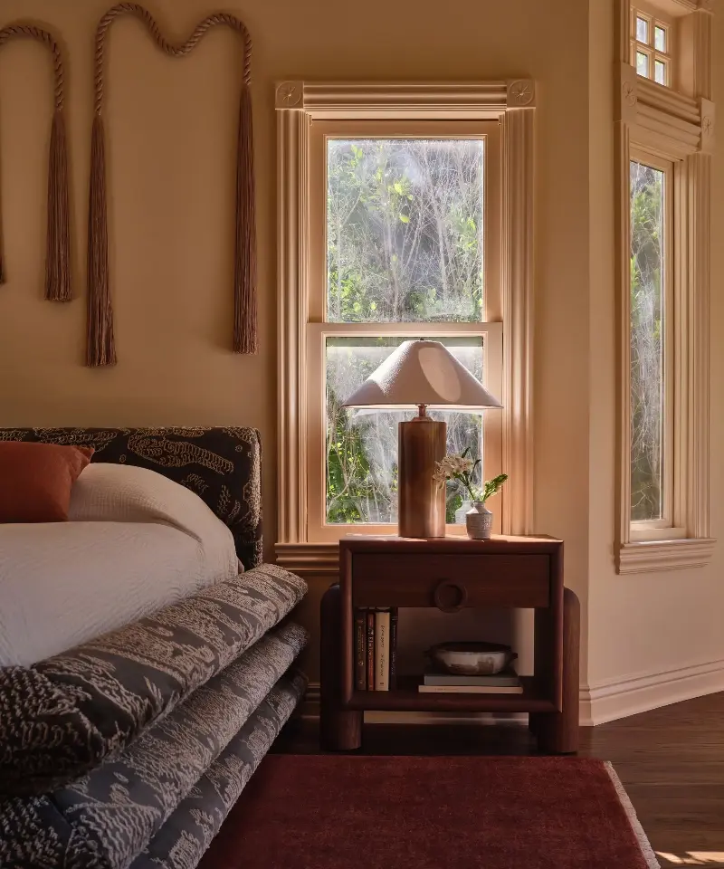 House of Honey avoids the cool-color trap with a warm, tonal wall-and-trim treatment, layered with dark wood, rich pattern and rust-red accents for depth. (Image credit: House of Honey Design / Michael P.H. Clifford Photography)